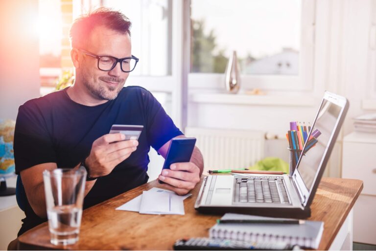 Man Paying Purchase With Credit Card On Phone