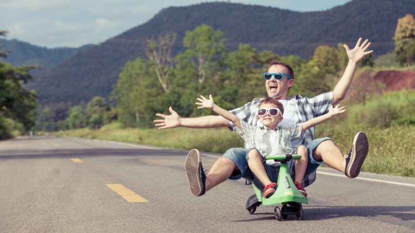 Father Son Scooting Sunglasses Outdoors Street