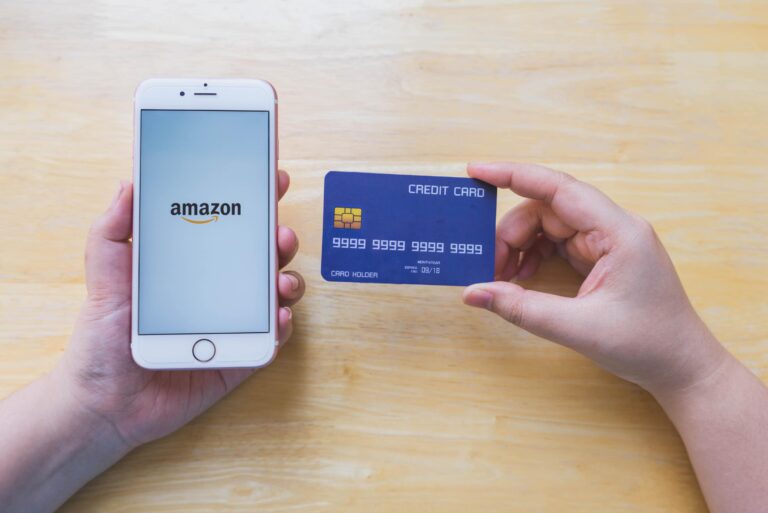 Hands Holding Iphone Displaying Amazon Credit Card