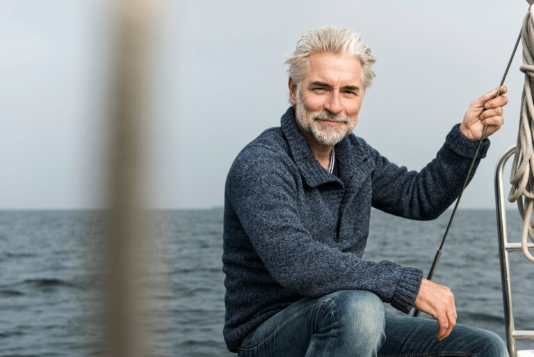 Mature Grey Haired Man Sailing Boat