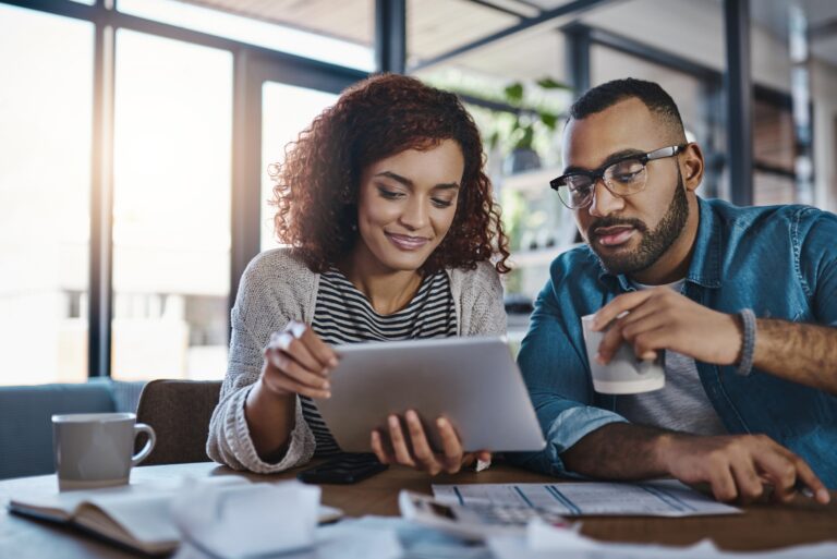 Couple Reviewing Their Finances To See If They Pay Off Their Credit Cards In Full If Their Credit Will Go Up